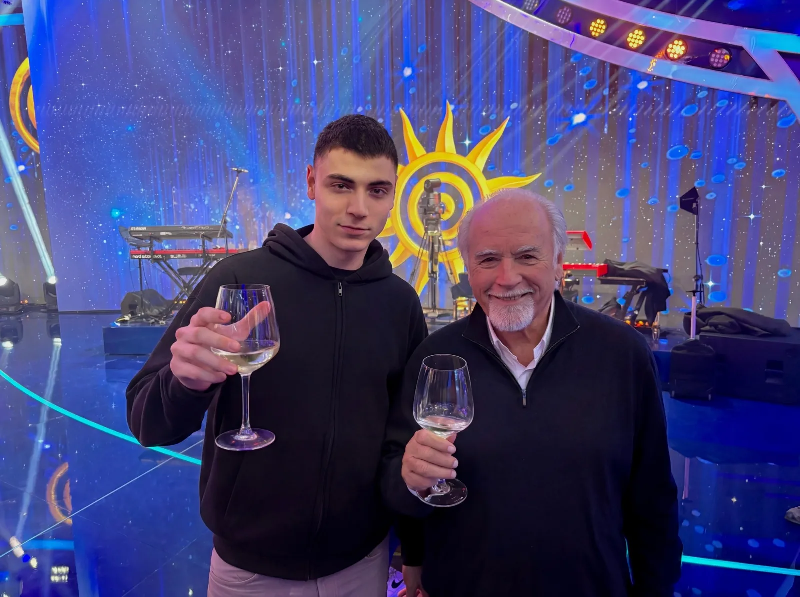 Alessandro Bigatti e Antonio Ricci brindano in studio, davanti al sole di Striscia la Notizia